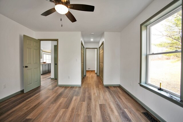 empty room with dark hardwood / wood-style flooring