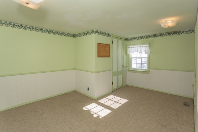 spare room with light colored carpet