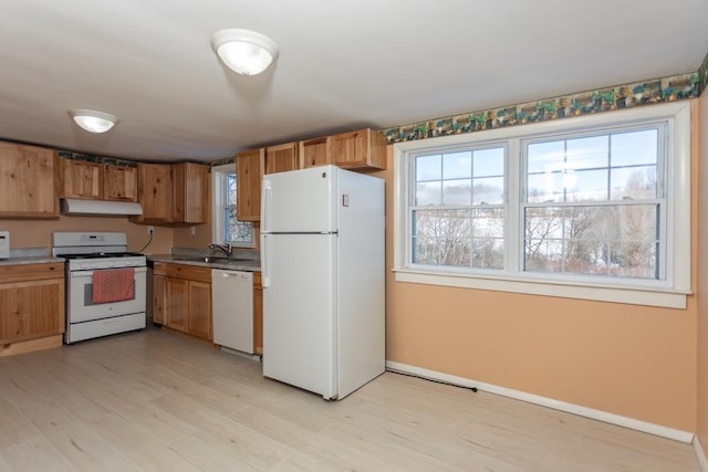 kitchen with sink, white appliances, and light hardwood / wood-style floors