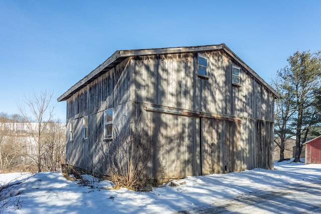 view of snow covered exterior with an outbuilding