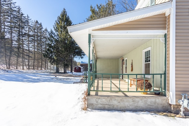 view of snow covered exterior with covered porch