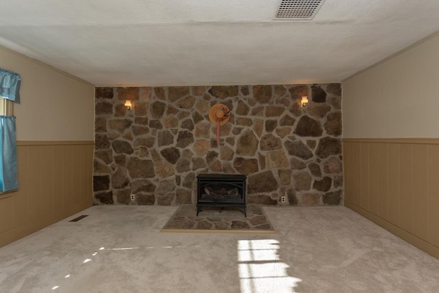 unfurnished living room with light colored carpet and a textured ceiling