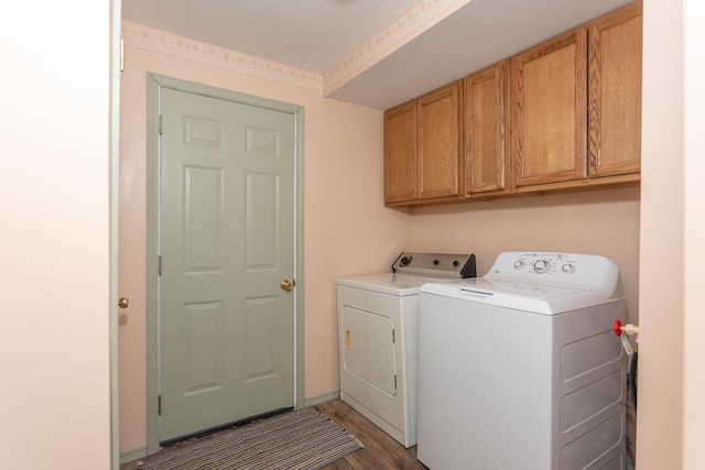 laundry room with cabinets, washer and dryer, and dark hardwood / wood-style flooring