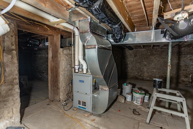 utility room featuring heating unit