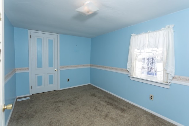 carpeted spare room with plenty of natural light