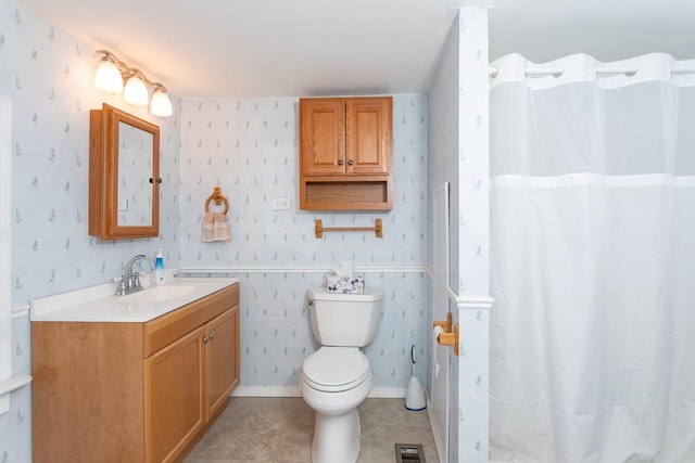 bathroom with vanity, a shower with shower curtain, and toilet