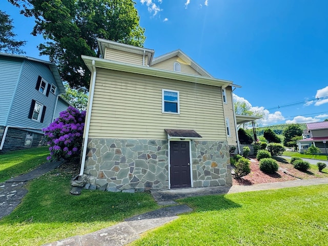 10 Ward Ave, Towanda, PA 18848 - rear view of house with stone siding and a lawn