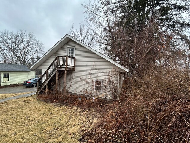 view of side of home with stairway