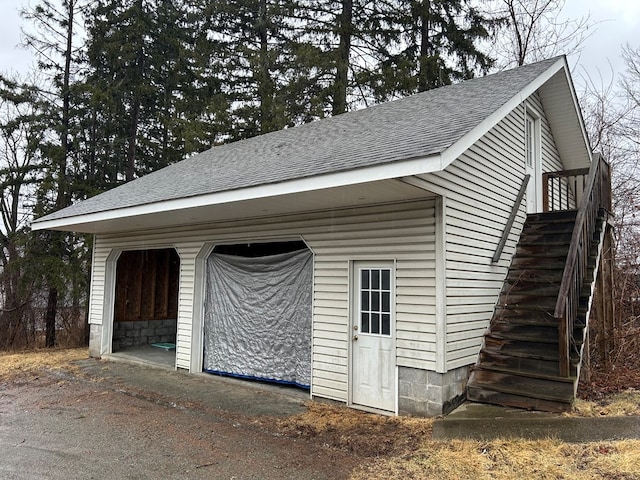 view of outdoor structure featuring an outbuilding and stairway