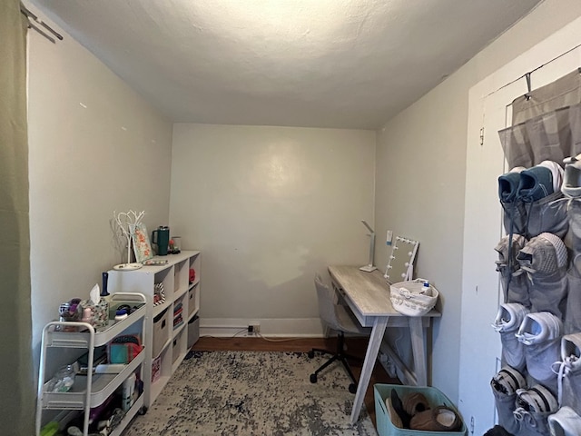 office area with baseboards and wood finished floors