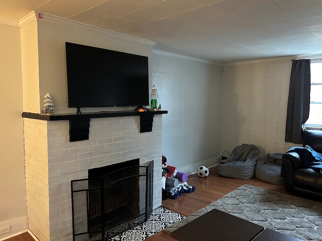 unfurnished living room with baseboards, a brick fireplace, wood finished floors, and crown molding