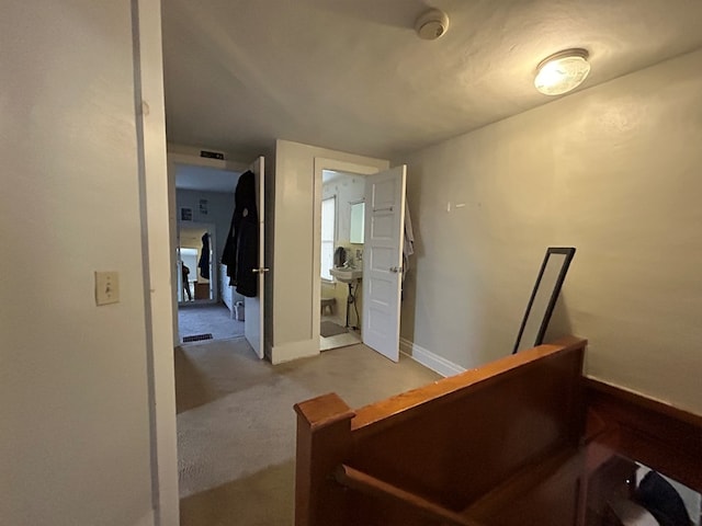 interior space with visible vents, carpet, and baseboards