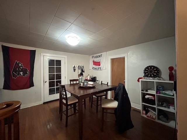 dining space featuring baseboards and dark wood finished floors