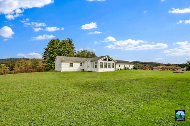 back of house featuring a yard