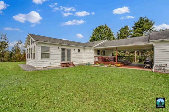 rear view of property featuring a yard