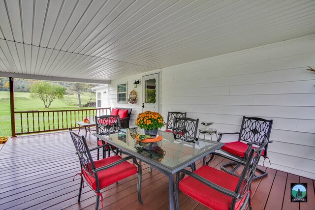 wooden terrace with a lawn