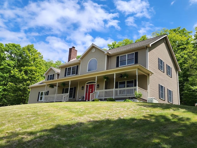 82 Cherry Tree Ln, Coudersport, PA 16915 - colonial house featuring a ceiling fan, a porch, a chimney, and a front lawn