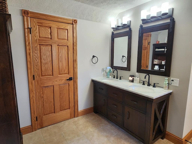 82 Cherry Tree Ln, Coudersport, PA 16915 - bathroom featuring a textured ceiling, double vanity, baseboards, tile patterned flooring, and lofted ceiling