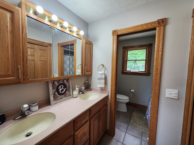 82 Cherry Tree Ln, Coudersport, PA 16915 - full bath featuring double vanity, toilet, tile patterned flooring, and a textured ceiling