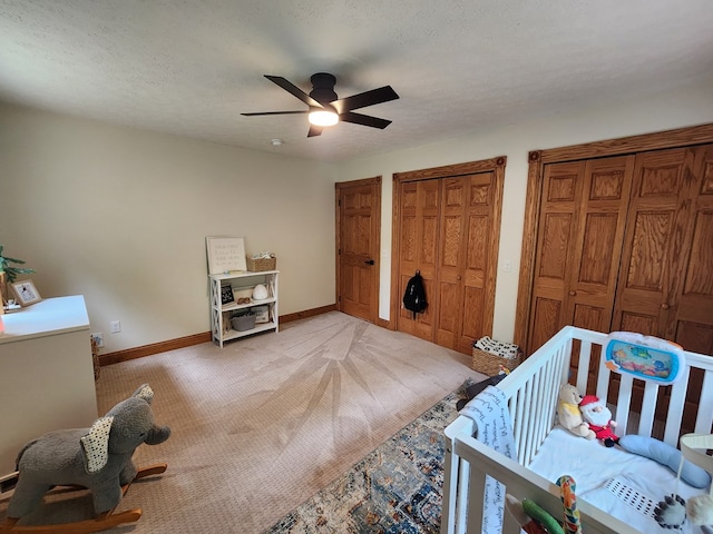 82 Cherry Tree Ln, Coudersport, PA 16915 - bedroom with light carpet, two closets, baseboards, and ceiling fan