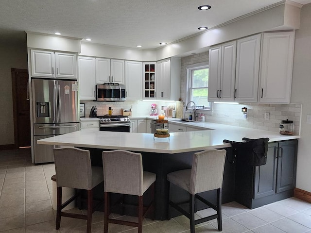 82 Cherry Tree Ln, Coudersport, PA 16915 - kitchen with stainless steel appliances, a breakfast bar, a sink, light countertops, and recessed lighting
