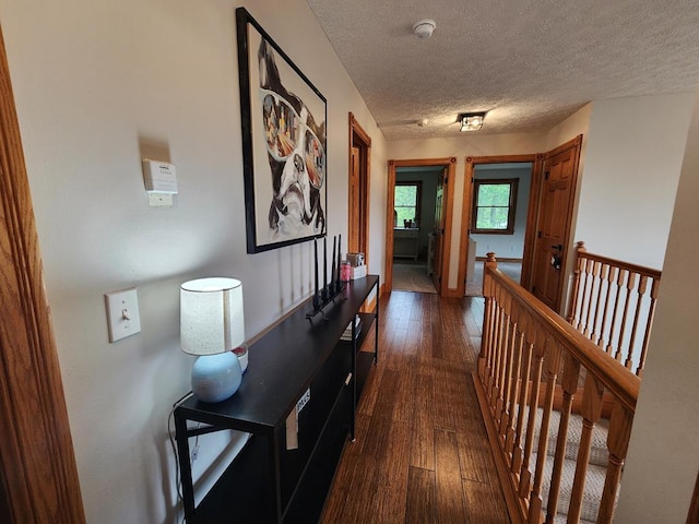 82 Cherry Tree Ln, Coudersport, PA 16915 - hallway with dark wood-style floors, a textured ceiling, and an upstairs landing