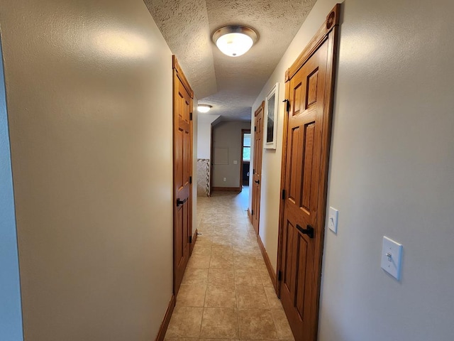 82 Cherry Tree Ln, Coudersport, PA 16915 - hallway featuring a textured ceiling, baseboards, and light tile patterned flooring