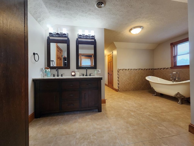 82 Cherry Tree Ln, Coudersport, PA 16915 - bathroom featuring double vanity, a soaking tub, tile patterned flooring, tile walls, and a textured ceiling