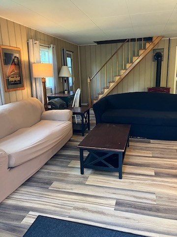 32 Investment Ln, Milan, PA 18831 - living area featuring stairs, wood walls, and wood finished floors