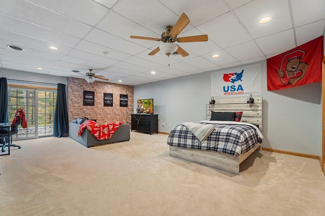 bedroom featuring carpet flooring, ceiling fan, a drop ceiling, and access to exterior