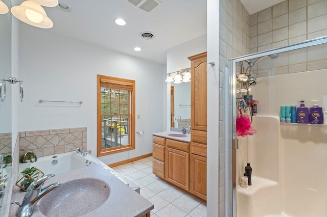 bathroom with plus walk in shower, vanity, and tile patterned floors