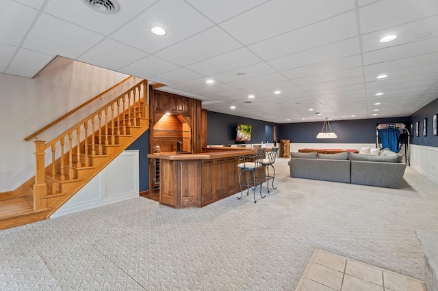 bar featuring carpet flooring and hanging light fixtures