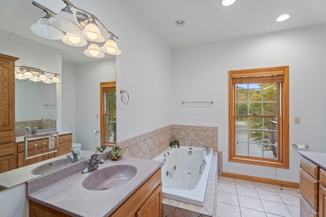 bathroom featuring toilet, vanity, tiled bath, and tile patterned floors