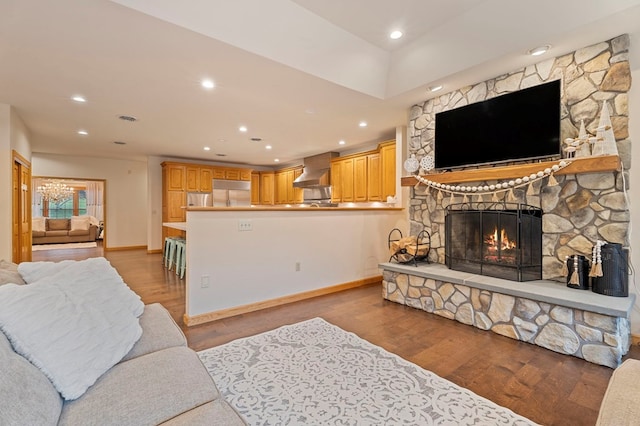 living room with a fireplace and light wood-type flooring