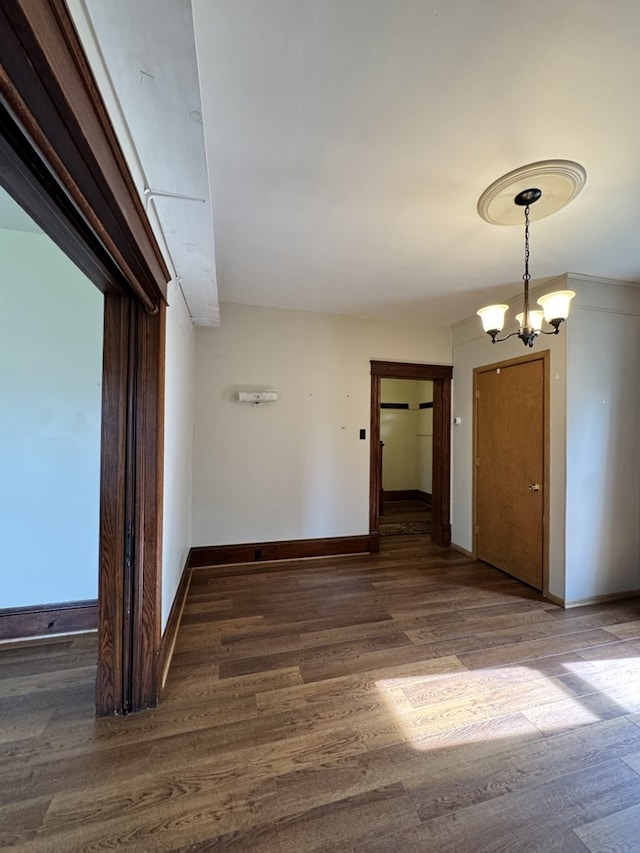 519 N Elk Ave, Kane, PA 16735 - unfurnished room featuring wood finished floors and a chandelier