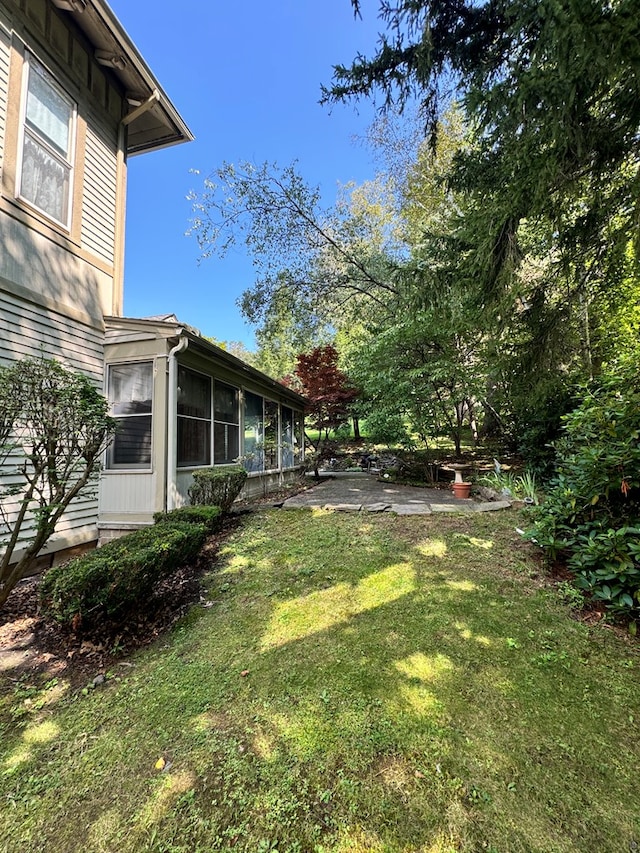 view of yard with a sunroom