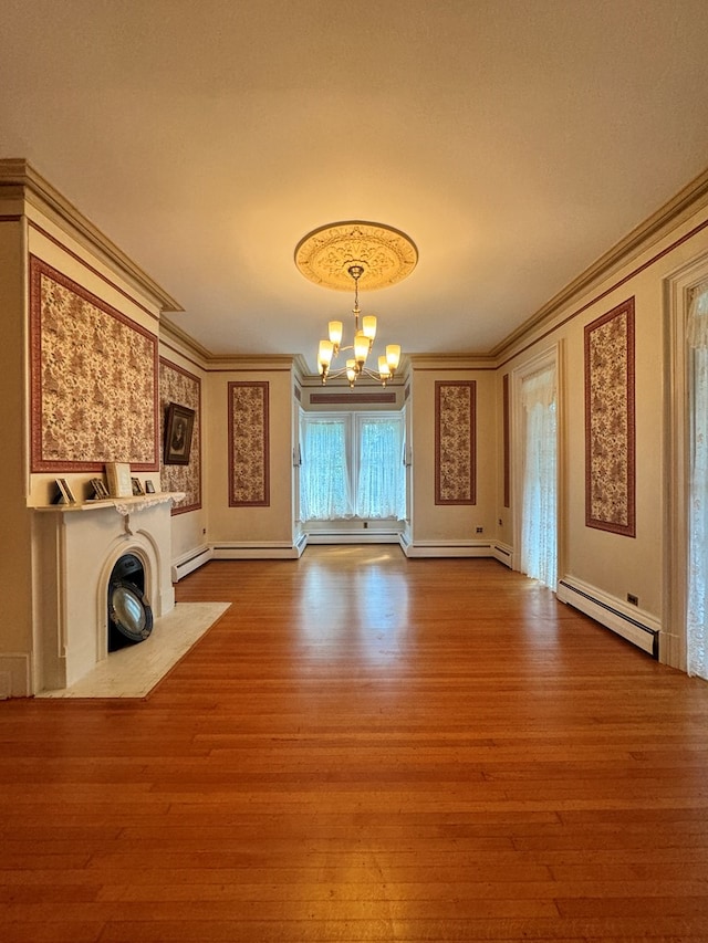 unfurnished living room featuring hardwood / wood-style flooring, an inviting chandelier, crown molding, and a baseboard radiator