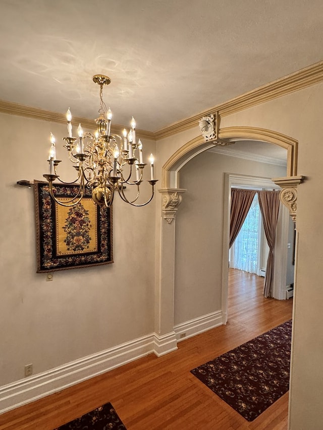 unfurnished dining area with crown molding and hardwood / wood-style floors