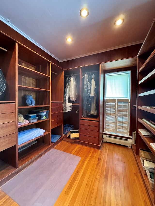 walk in closet featuring light hardwood / wood-style floors and baseboard heating