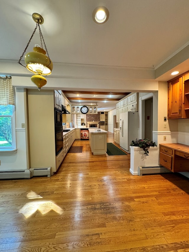 kitchen featuring a center island, white refrigerator with ice dispenser, a baseboard heating unit, and light hardwood / wood-style flooring