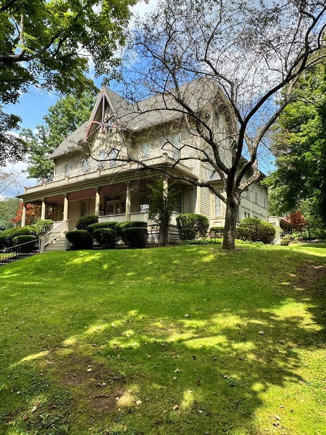 view of property exterior with a lawn and covered porch