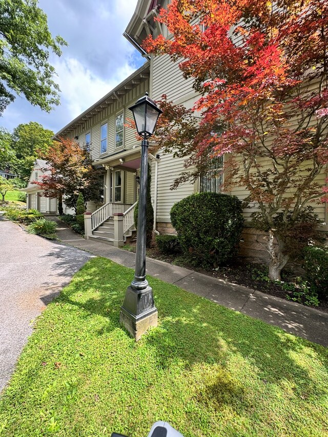 view of property exterior featuring a lawn