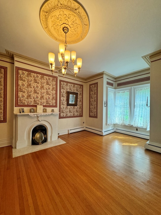 unfurnished living room with ornamental molding, light wood-type flooring, and a notable chandelier