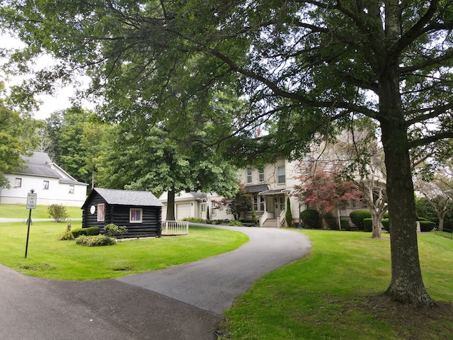 view of front of home with a front yard and a garage