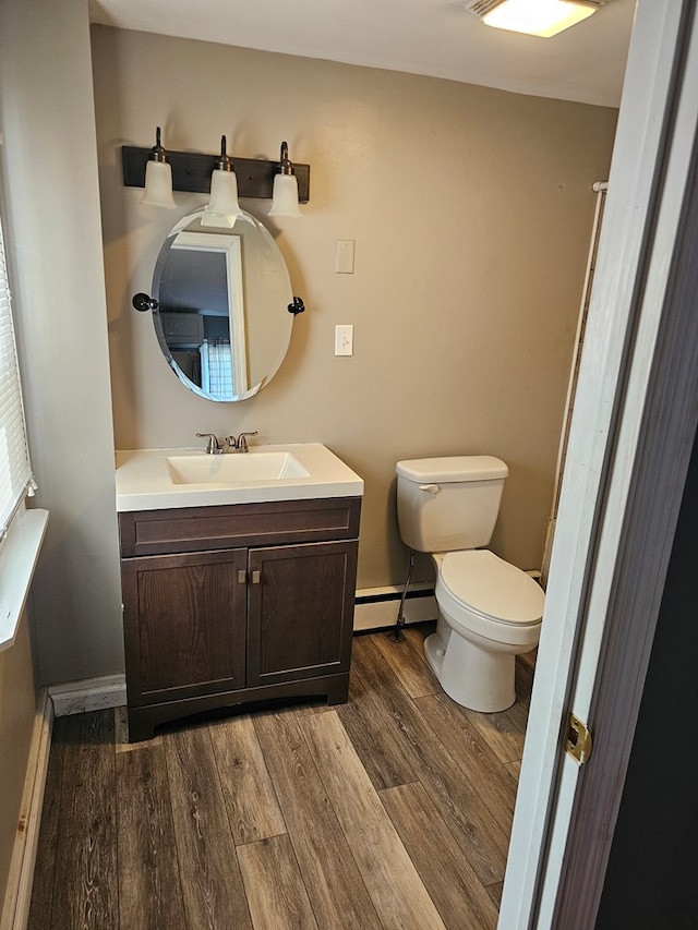 202 Cliff St, Montrose, PA 18810 - bathroom featuring baseboard heating, vanity, wood finished floors, toilet, and baseboards
