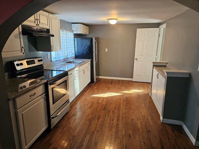 202 Cliff St, Montrose, PA 18810 - kitchen with appliances with stainless steel finishes, under cabinet range hood, a sink, dark wood-style floors, and white cabinets