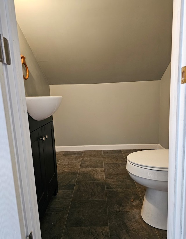 202 Cliff St, Montrose, PA 18810 - bathroom with toilet, vaulted ceiling, vanity, and baseboards