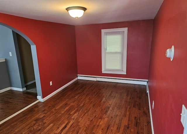 202 Cliff St, Montrose, PA 18810 - spare room with a baseboard radiator, arched walkways, wood finished floors, and baseboards