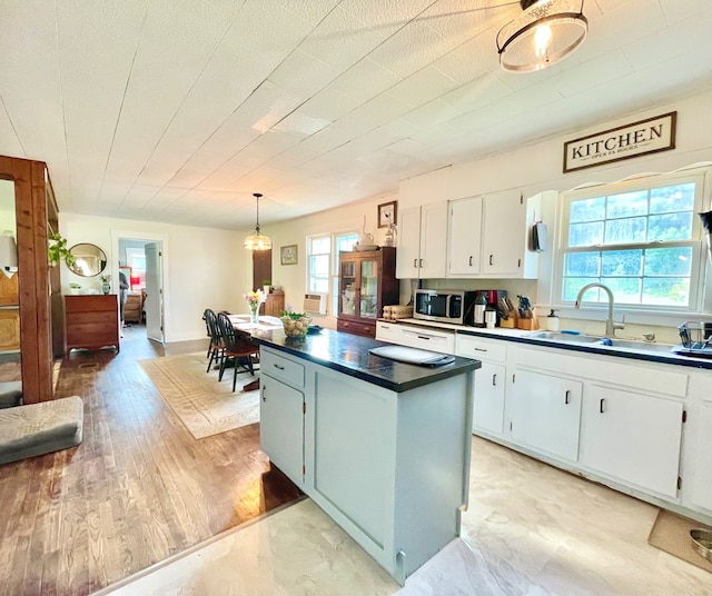 403 Horse Thief Run Rd, Wellsboro, PA 16901 - kitchen featuring stainless steel microwave, white cabinets, dark countertops, and a center island