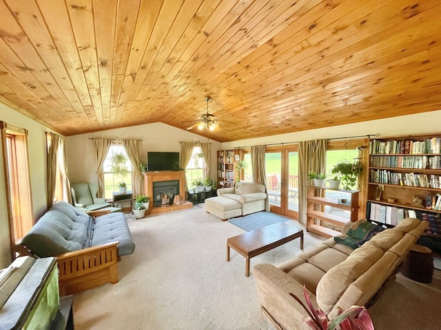 403 Horse Thief Run Rd, Wellsboro, PA 16901 - living room featuring carpet floors, wood ceiling, vaulted ceiling, a fireplace with raised hearth, and a ceiling fan